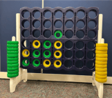 giant four in line game with yellow and green circles