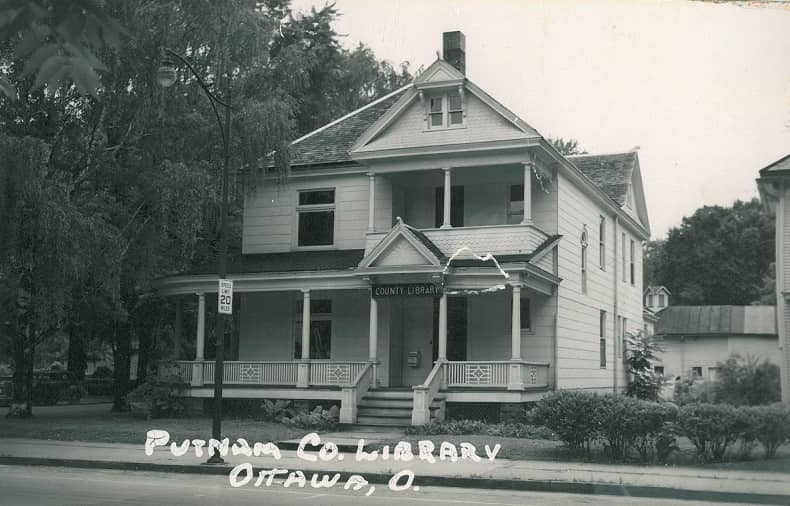 house with trees County Library sign on house, Putnam Co Library Ottawa, O. written on picture