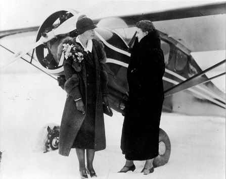Amelia Erhart and Loretta Schimmoler infront of airplane Cleveland Airport