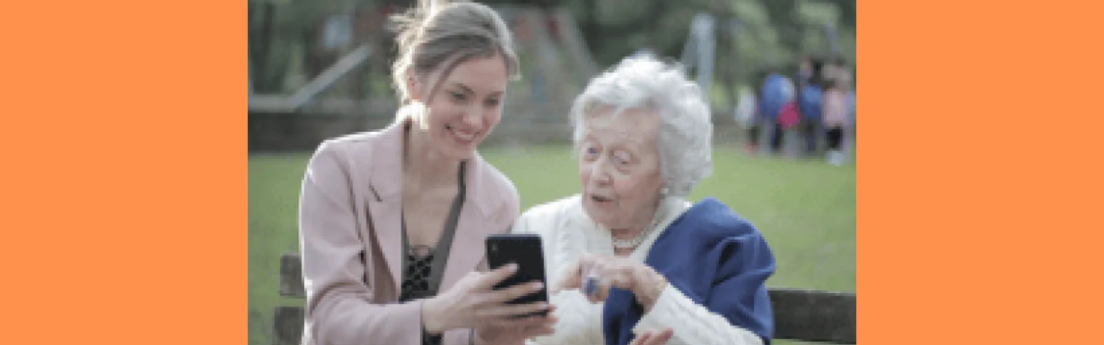 a younger and an older woman discussing something on a cell phone