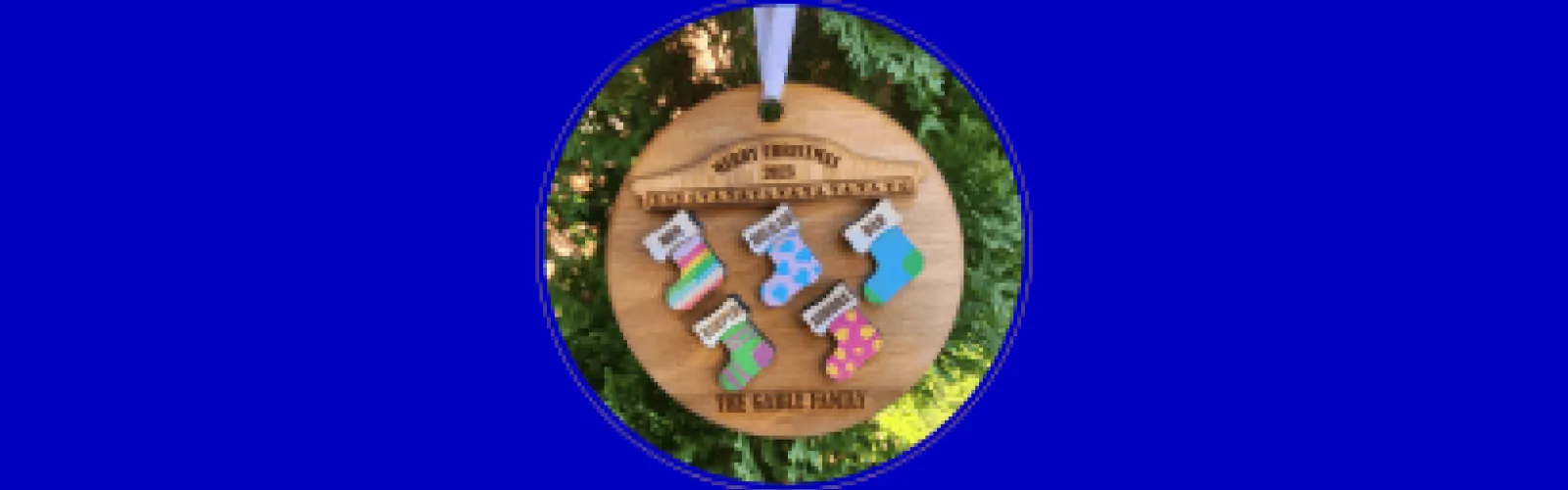 round wooden ornament with stockings 