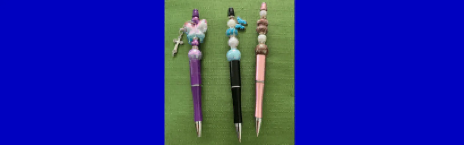 three beaded pens 
