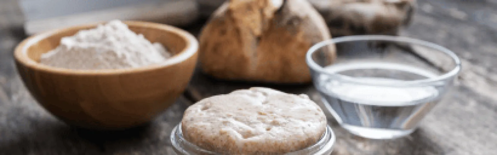 flour water sourdough starter and a loaf of bread