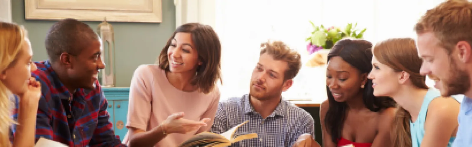 3 men and 4 women discussing a book