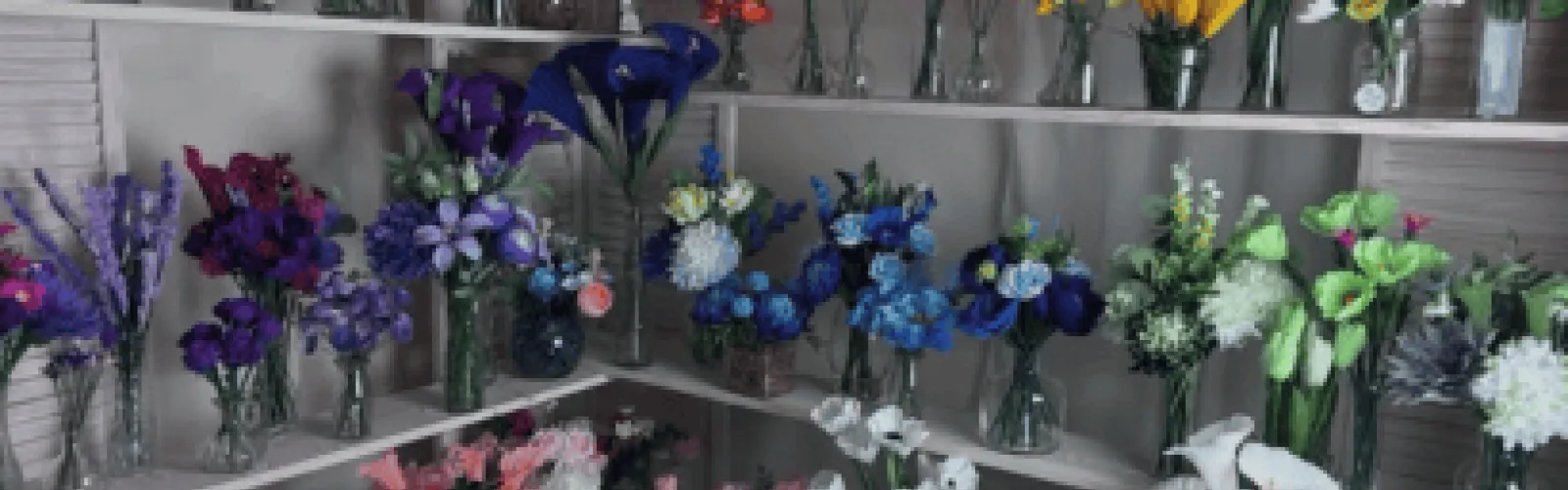 purple blue and green bouquets in clear vases