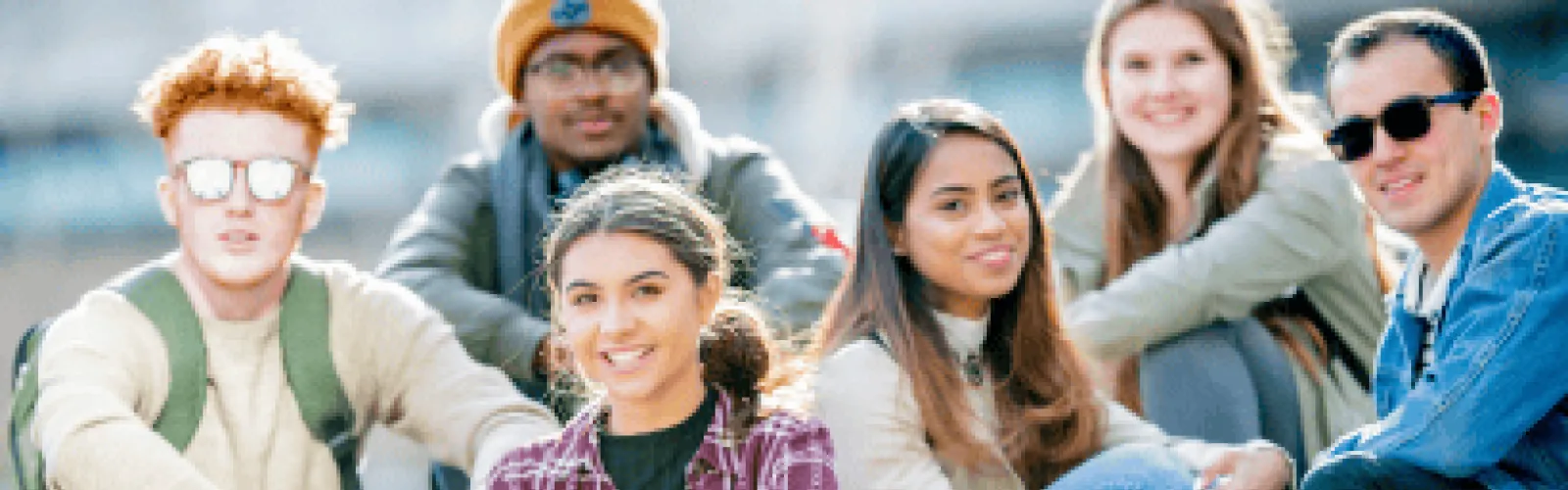 six teens sitting outside